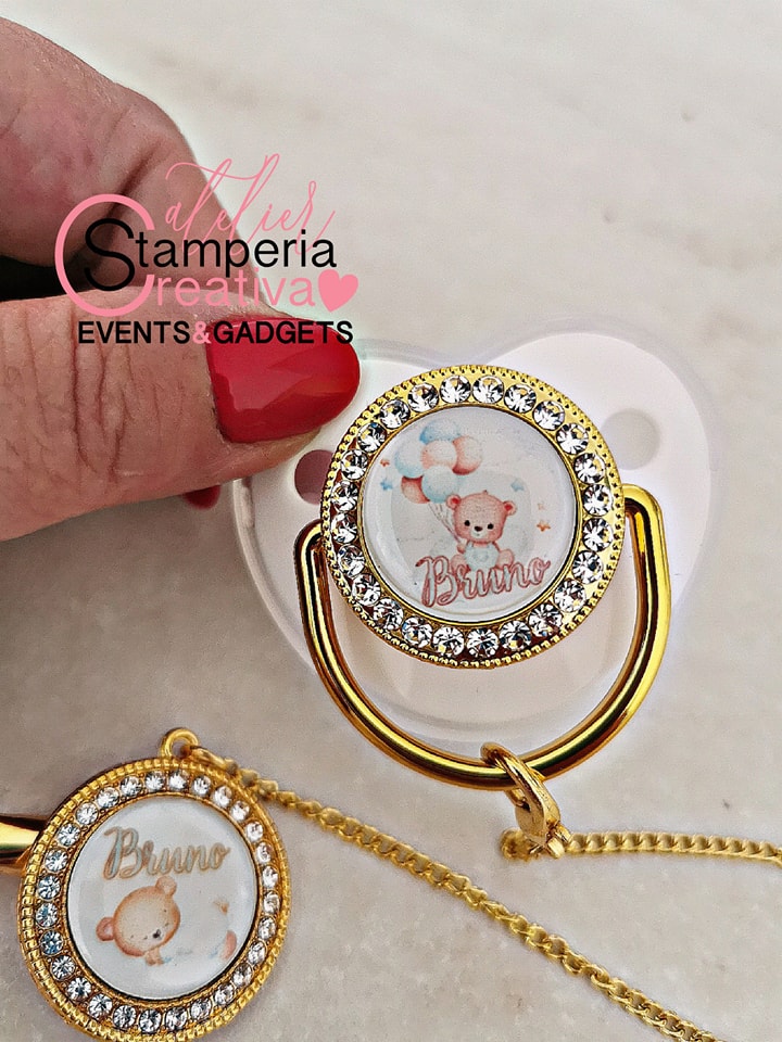 Ciuccio bianco/oro completo di catenella